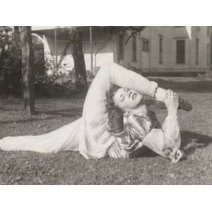  Flexible Woman in a Garden Bending Her Leg Above Her Head 