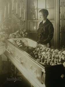   MORTEM YOUNG WOMAN GRIEVES OVER DEAD HUSBAND IN COFFIN TOUCHING  