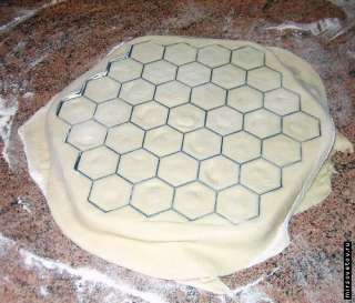 Whenall the cells are filled we roll the second layer of dough. Than 