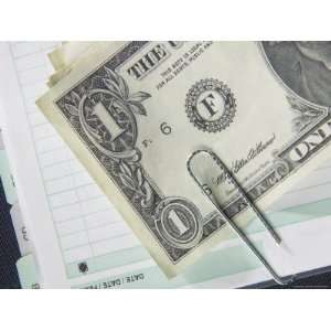 American Dollar Bill Paper Clipped to Accounting Book Photographic 