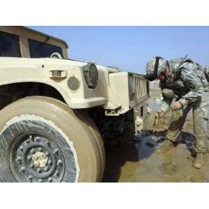 Staff Sergeant Unties a Rope to Tow a Humvee out of the Mud During a 