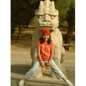  A Girl Poses Before a Carved Mythical Creature on the 