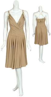 Attractive cocktail dress features gold lambskin straps and wide 