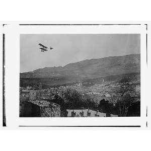  Breguet biplane,type 1910,flying over a town,possibly in 