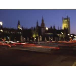 Time Lapse of Bright Red Streaks on City Street by Parliament Building 